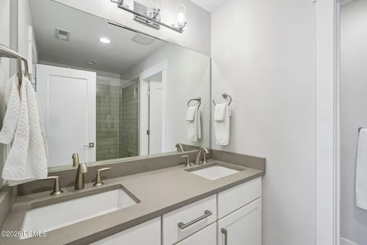 Primary bath with double vanity and quartz counter.