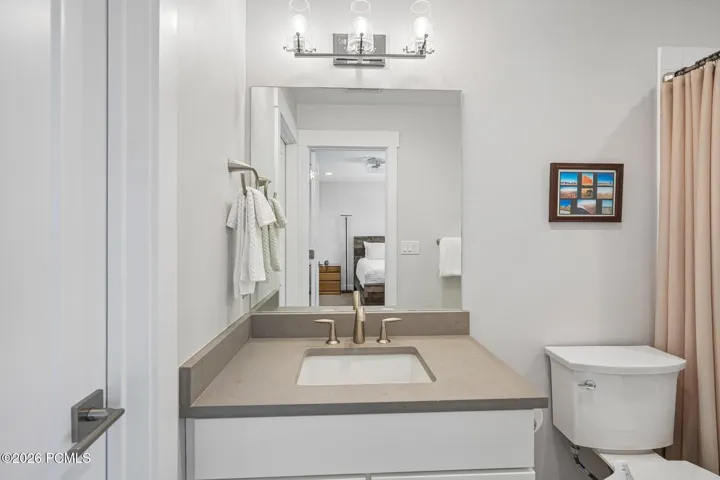Full bath with vanity, tub, and tile flooring.