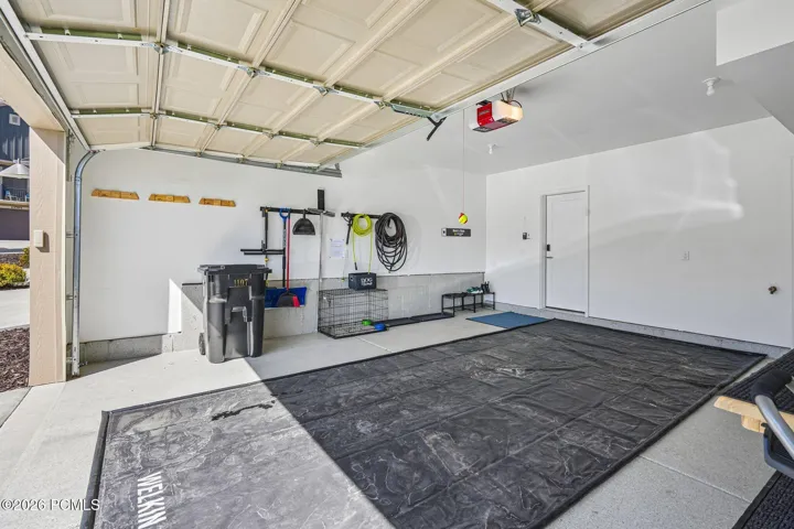 Garage interior with finished walls and room for gear storage.