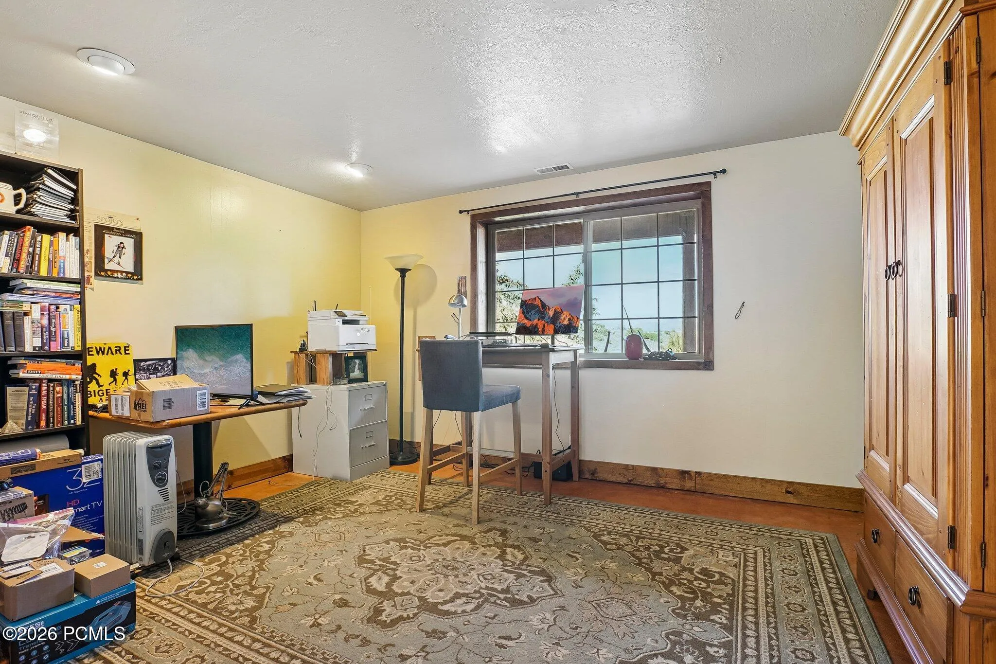 A lower-level flex room currently used as a home office, with a good window, good light, and enough distance from the main level to focus.A lower-level flex room currently used as a home office, with a good window, good light, and enough distance from the main level to focus.Lower-level flex room set up as a home office, with a window, shelving, and a door to the adjacent hallway.
