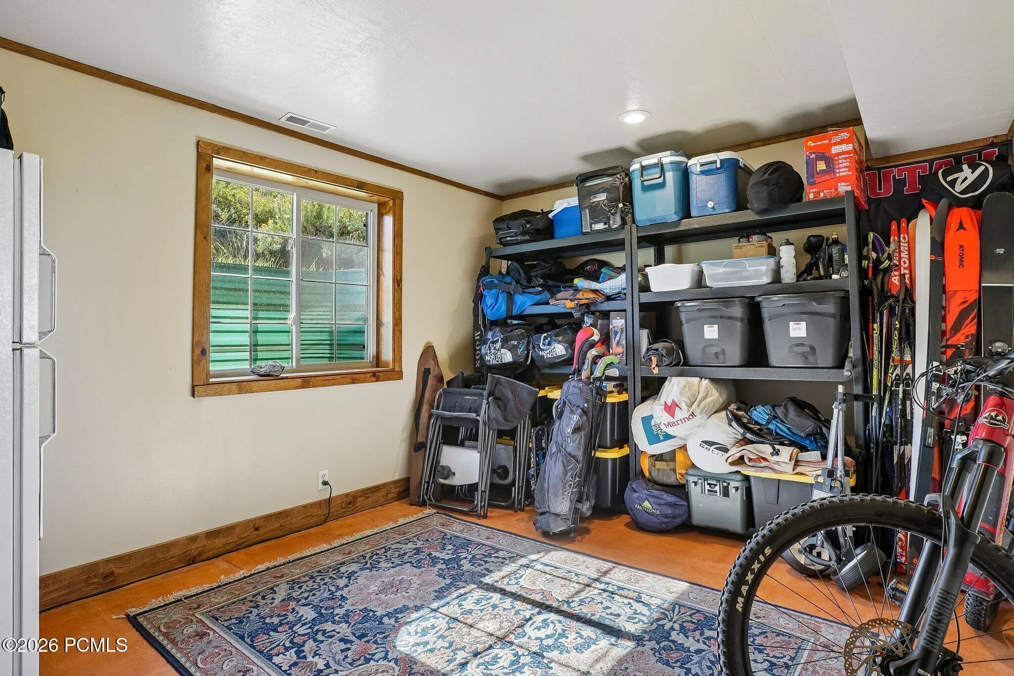 The gear room, with shelving for bikes, skis, and the rest of the equipment that makes living up here worthwhile.The gear room, with shelving for bikes, skis, and the rest of the equipment that makes living up here worthwhile.Lower-level storage room with shelving for recreation gear, bikes, and skis, and a window on the exterior wall.