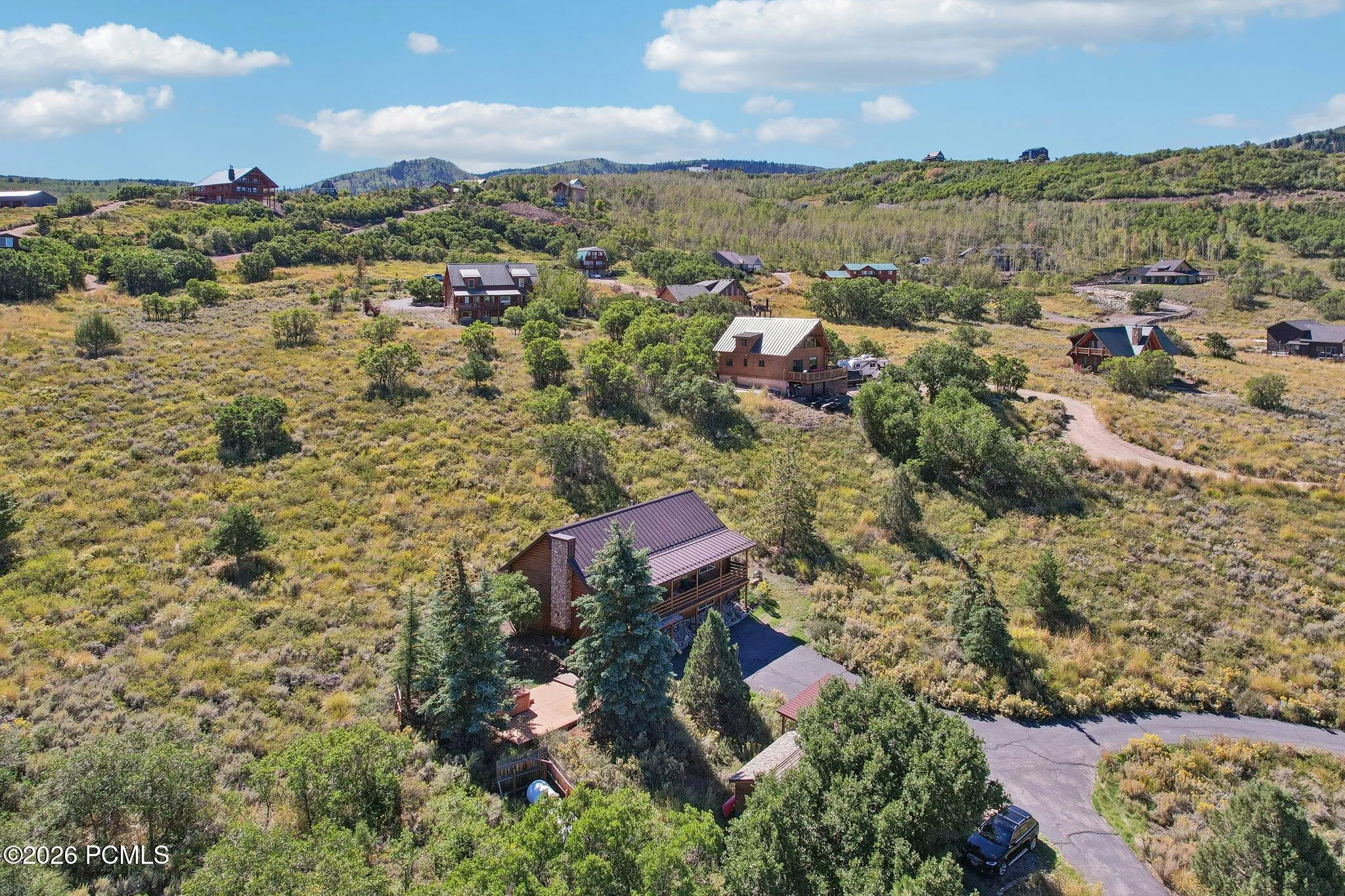 Pines and natural vegetation on a gradual slope, which buys privacy without a driveway that becomes a problem in February.Pines and natural vegetation on a gradual slope, which buys privacy without a driveway that becomes a problem in February.Aerial view of the home surrounded by pines and natural vegetation on a gradual slope in Timber Lakes.