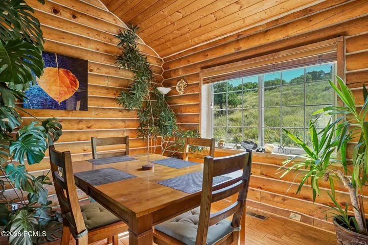 The dining area sits beside a large window on the meadow and holds the afternoon light, which is much of the reason to eat up here instead of down in town.