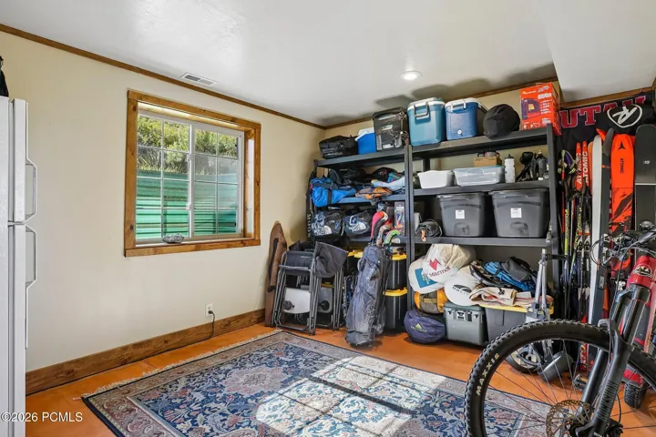 The gear room, with shelving for bikes, skis, and the rest of the equipment that makes living up here worthwhile.The gear room, with shelving for bikes, skis, and the rest of the equipment that makes living up here worthwhile.Lower-level storage room with shelving for recreation gear, bikes, and skis, and a window on the exterior wall.