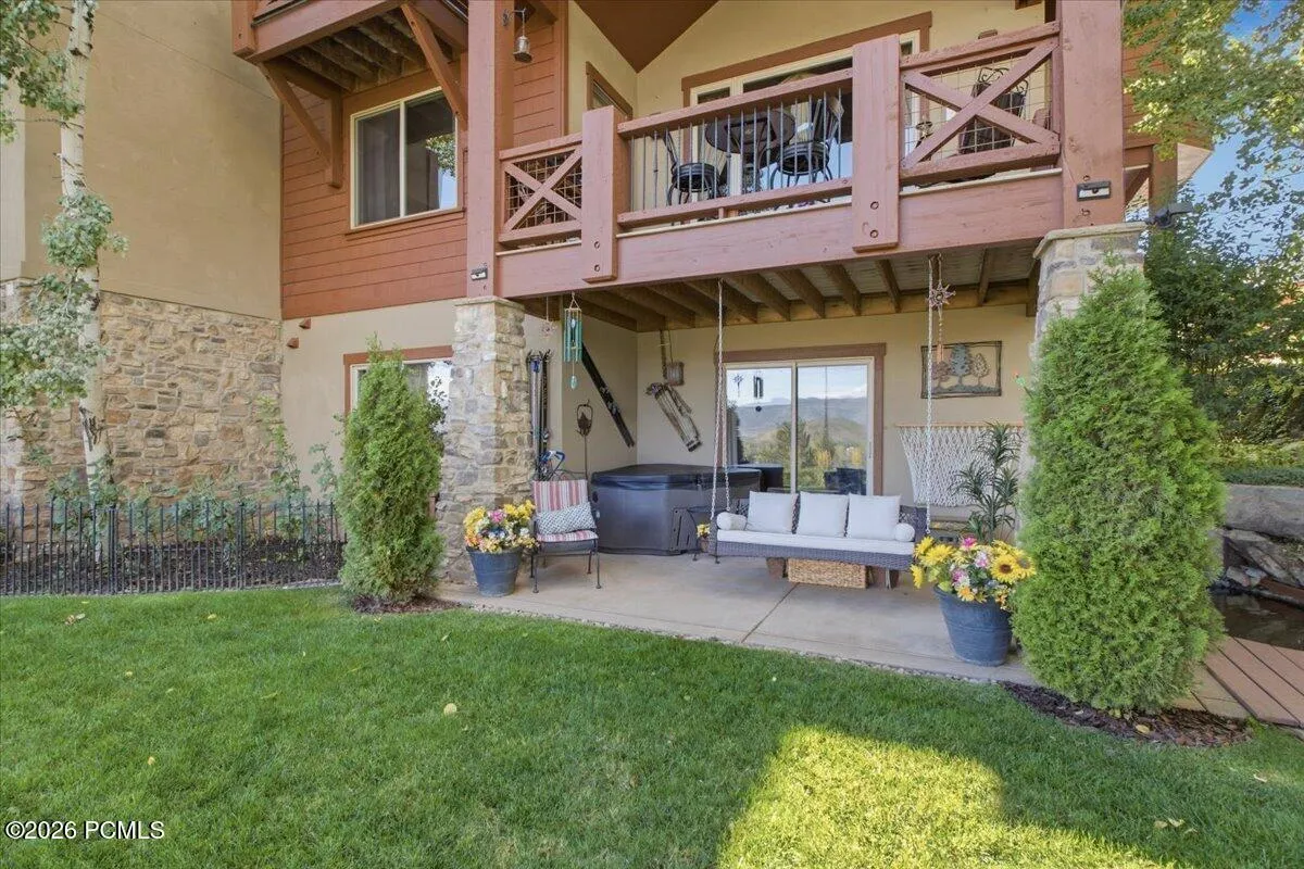 Covered patio featuring a hot tub, and a relaxing swing