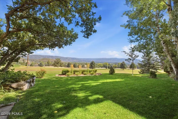 INCREDIBLE views of the valley, golf course, and memorial hill, featuring an expansive manicured lawn with mature shade trees.