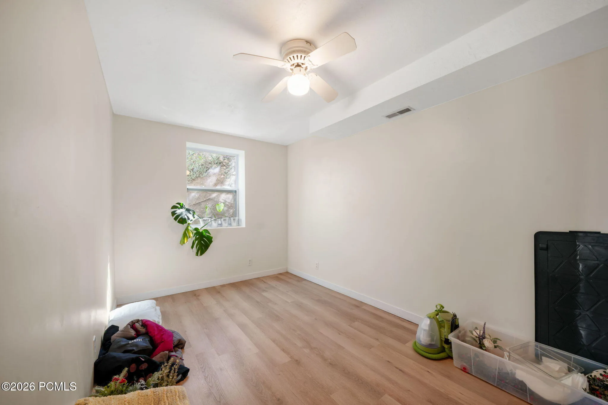 Recessed window, wood-finish flooring, ceiling fan, and overhead lighting