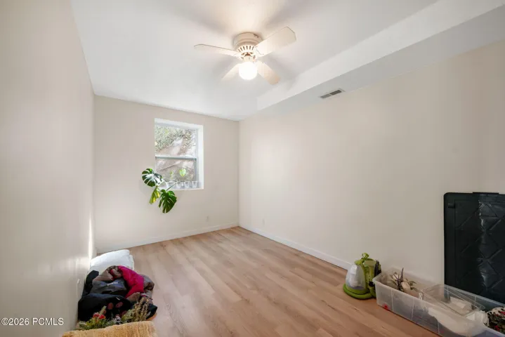 Recessed window, wood-finish flooring, ceiling fan, and overhead lighting