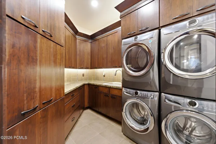 Offering laundry on both levels of the home, this main Laundry Room is conveniently located just off the Mud Room