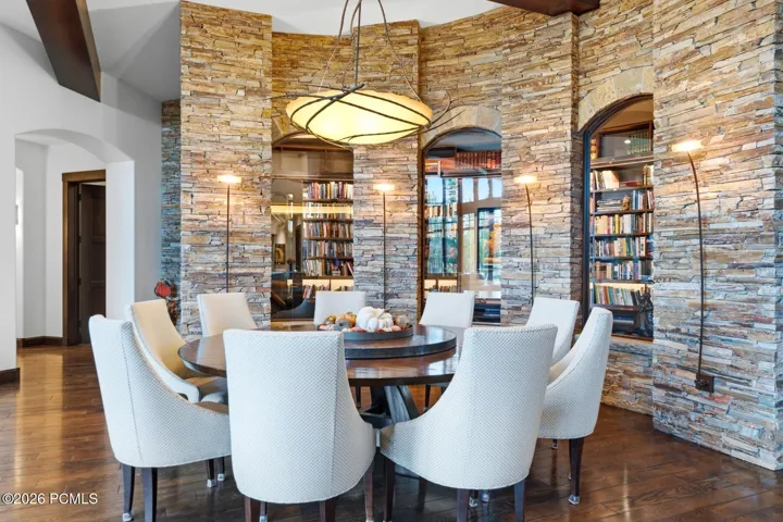 Set against a one-of-a-kind backdrop, this curved library is also conditioned to be a wine room and Sellers have all the shelving components for it to be either.