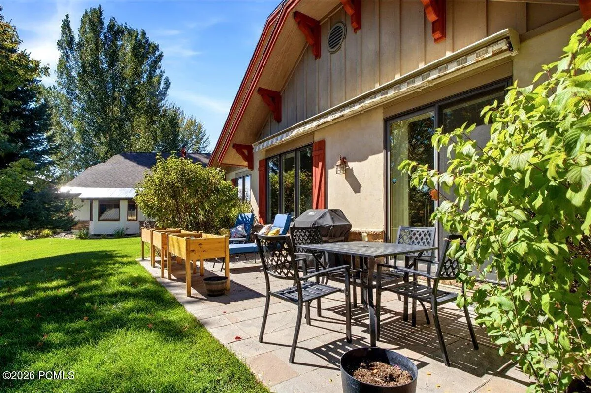 Stone paver patio featuring space and mature landscaping