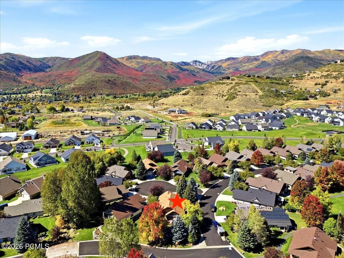 Aerial view of home surrounded by beautiful mountains