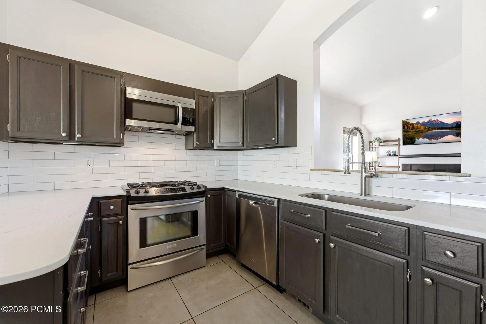 Gas range, built-in microwave and a deep undermount sink.