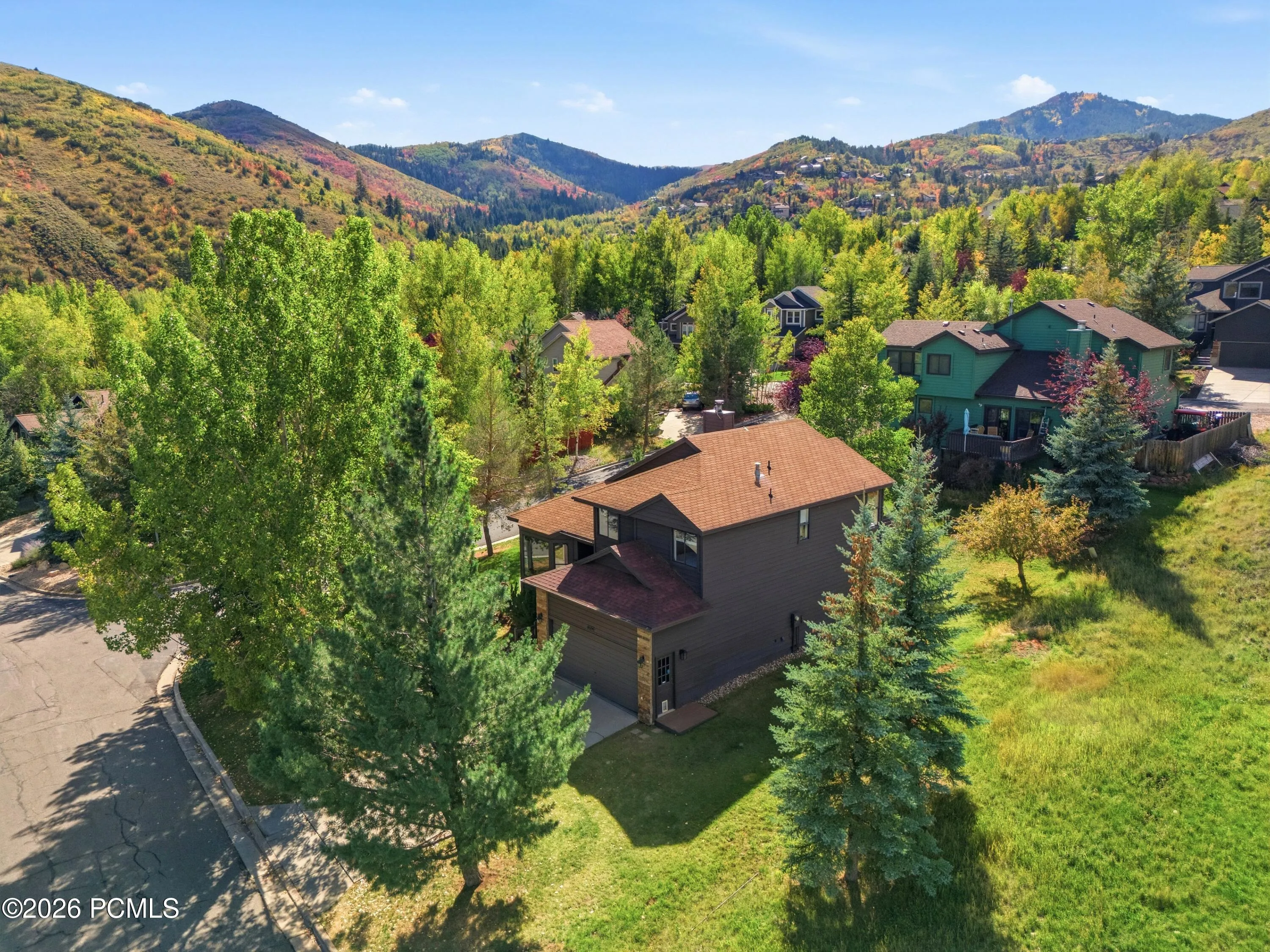 Classic mountain home on a corner lot with mature trees.