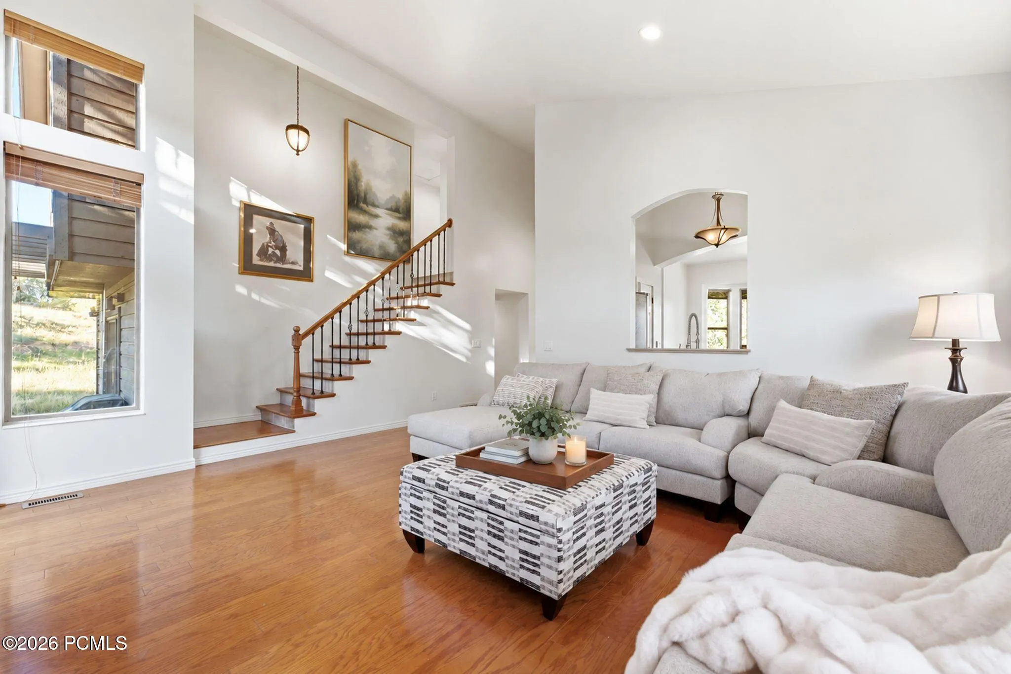 Vaulted great room with gas fireplace and treetop views. Virtually staged.
