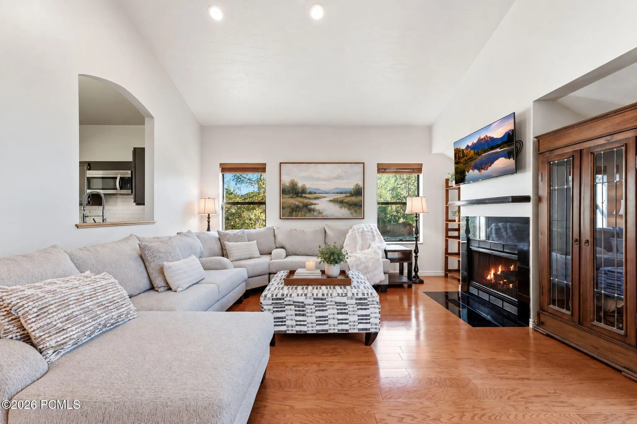 Open sightlines from the front entry through the great room to the kitchen. Virtually staged.