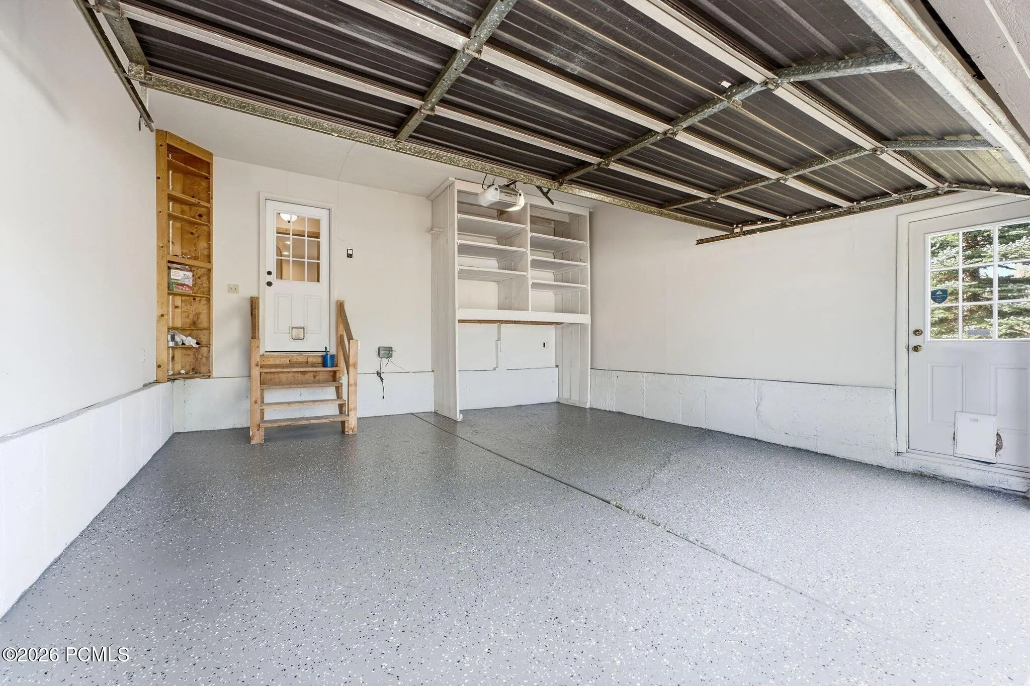 Attached two-car garage with a freshly painted floor.