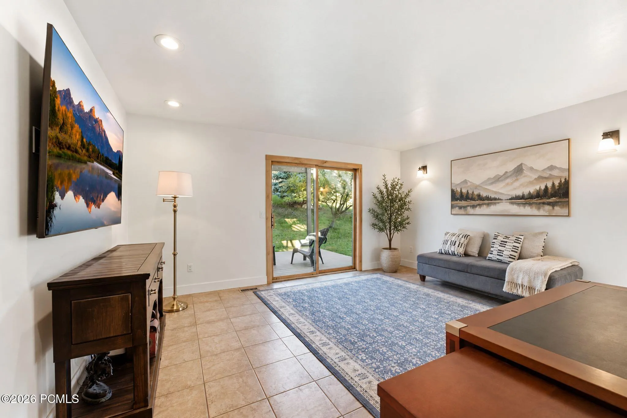 Lower-level family room | Office | 4th Bedroom with a wall-mounted TV and space to spread out.
