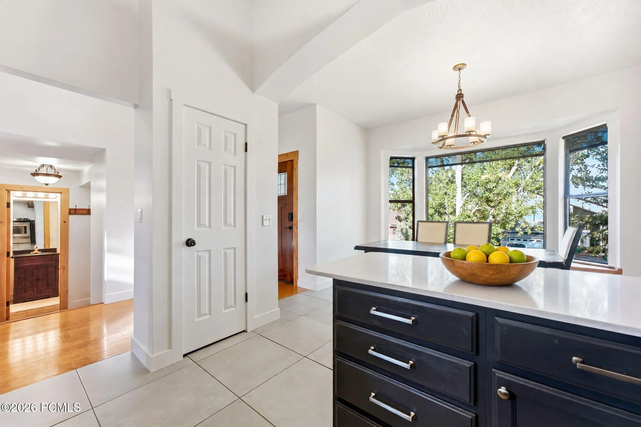 Dining flows straight into the kitchen, with quartz counters and stainless appliances. Virtually staged.