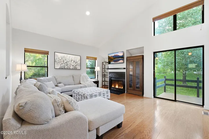 Great room with a wall of glass to the deck and backyard.