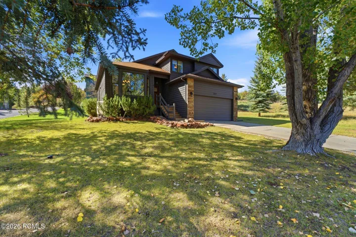Corner-lot home in Pinebrook with a freshly painted exterior and an attached two-car garage.
