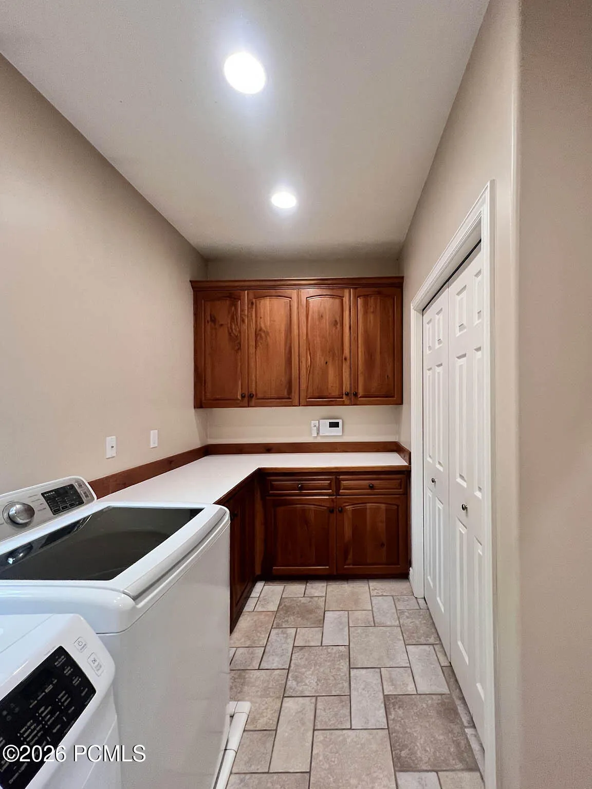Main-level laundry room with knotty cherry cabinetry