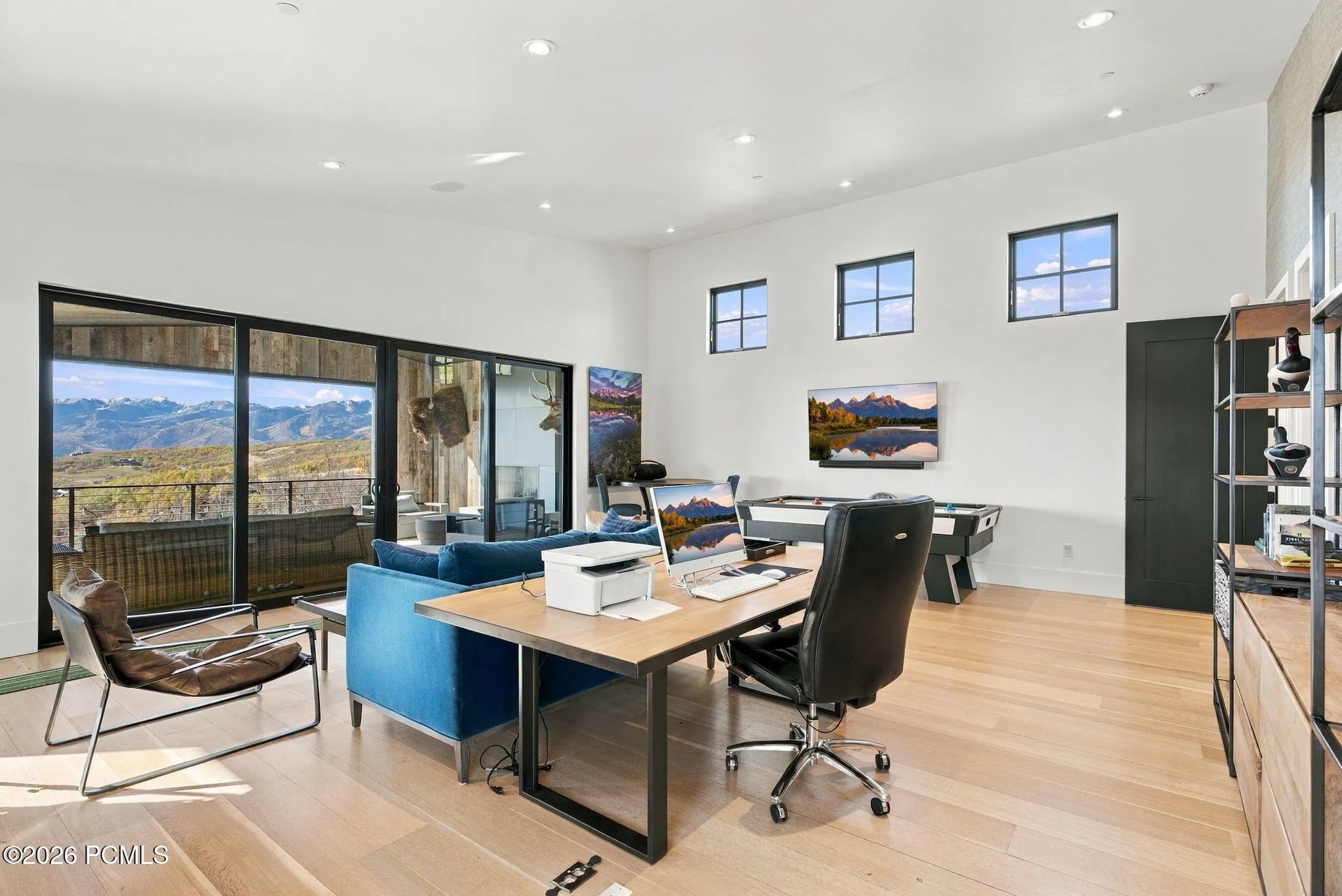 Indoor/outdoor office or bedroom with attached bathroom, floor to ceiling sliding glass doors and views of Park City & Deer Valley