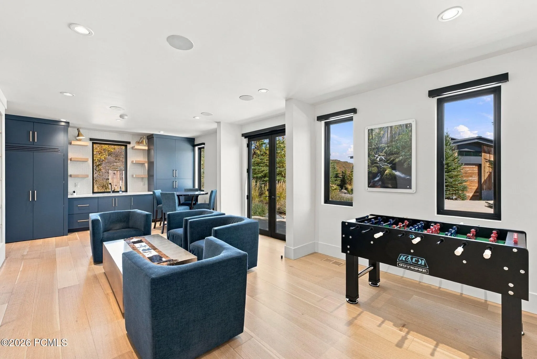 West wing of home featuring wetbar, game room, access to multiple patios and all three multi-level bedrooms