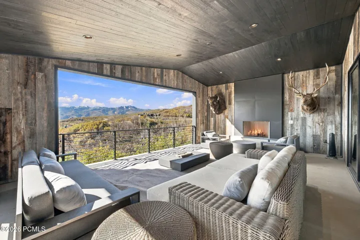 Indoor/outdoor office or bedroom with attached bathroom, floor to ceiling sliding glass doors and views of Park City & Deer Valley