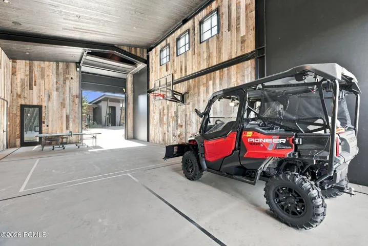 Detached recreation barn (~41' x 32') provides indoor pickleball and basketball courts. Oversized drive through roll-up doors provide convenient RV or boat storage. Upper and lower storage areas for all your outdoor equipment
