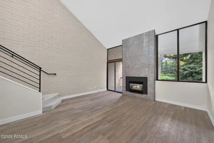 Living room with fireplace and interior stairs