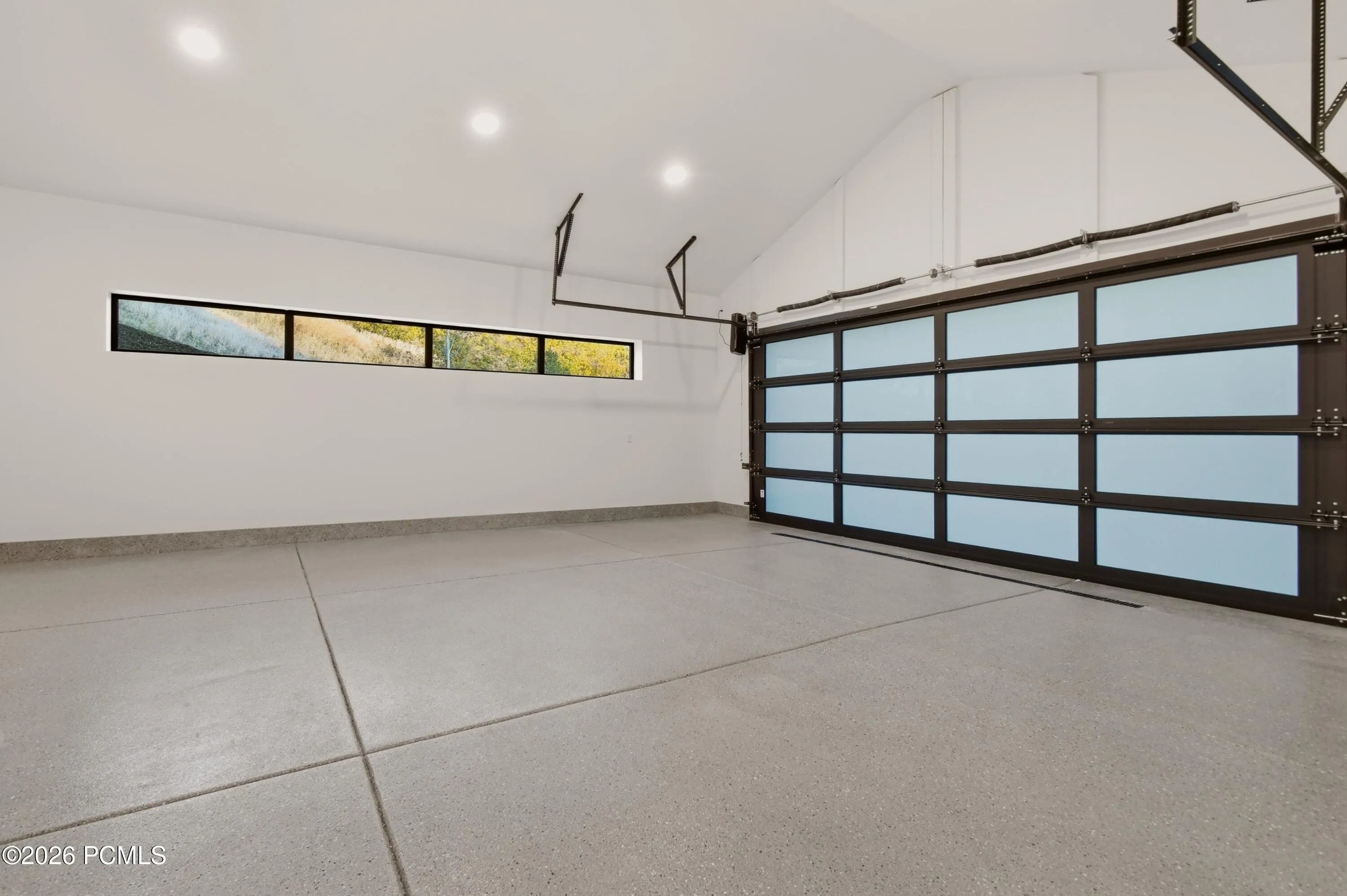 An impressive two car garage distinguishes itself with extraordinary scale, a finished concrete slab epoxy floor & soaring vaulted ceilings. The generous vertical clearance presents the possible opportunity to incorporate a vehicle lift, creating an enviable setting for an automotive collection, prized recreational vehicles or a tailored workshop. Far beyond conventional parking, this substantial space delivers the flexibility & elevated utility expected of a premier mountain estate.