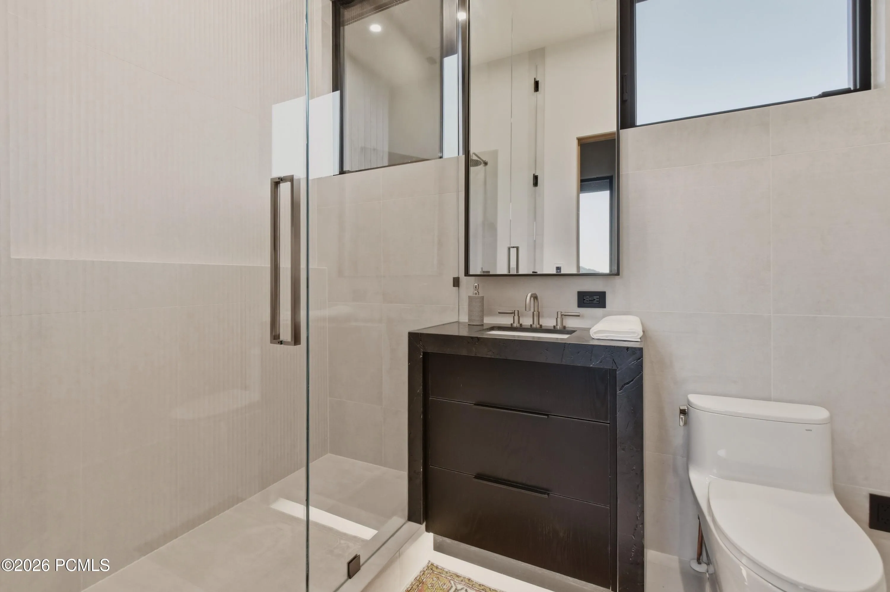 An expression of contemporary elegance through a suspended statement mirror that commands attention as a sculptural installation. Its graceful, floating form introduces an intriguing interplay of light, reflection & dimension, lending the vanity the curated presence of a private design gallery. An inspired departure from conventional bath design, this singular detail brings a sense of exclusivity & elevated aesthetic distinction to the space.