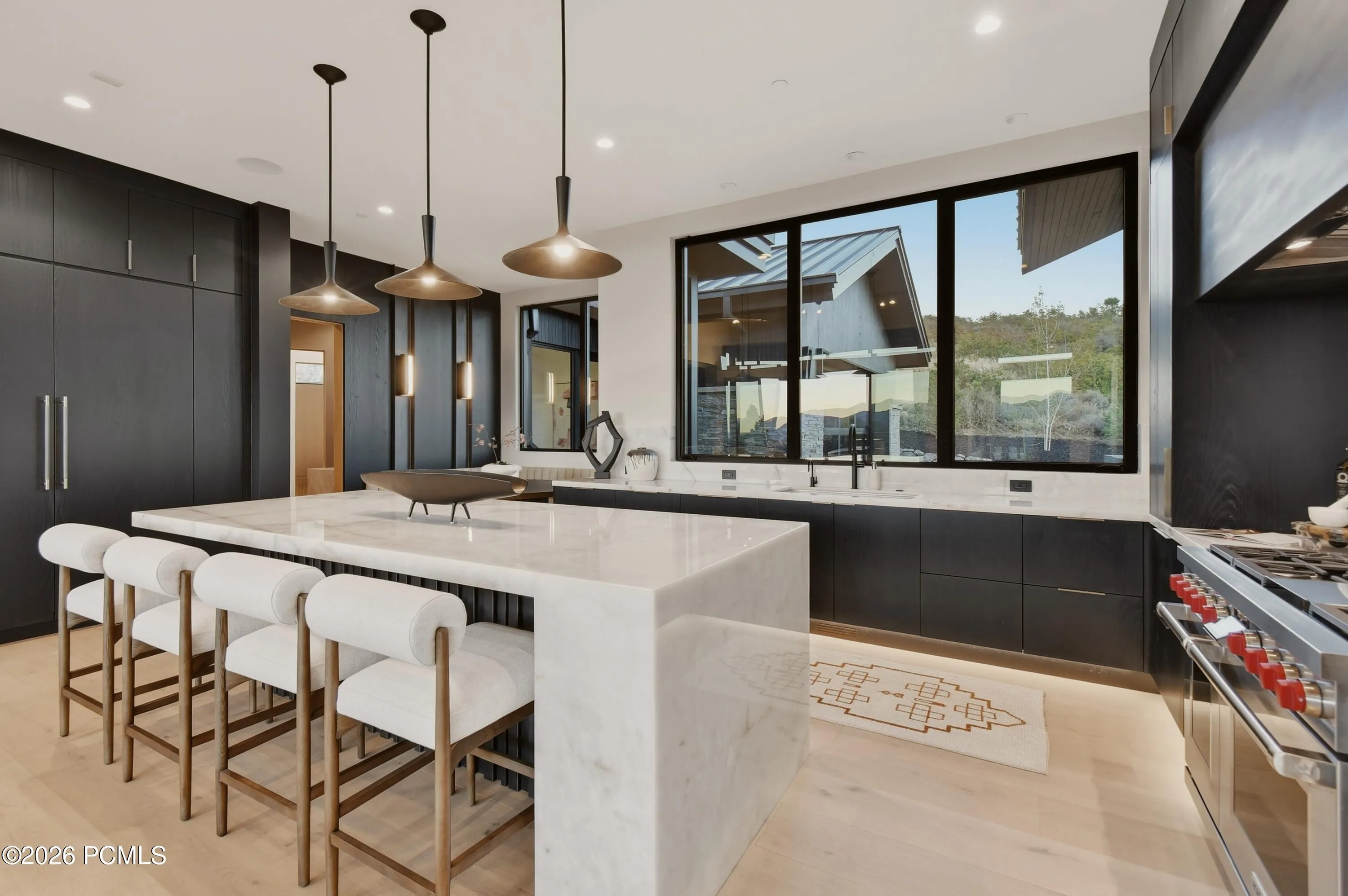 Complemented by refined cabinetry, premium Wolf & Sub-Zero appliances & meticulously curated finishes, this exceptional space balances culinary performance with understated luxury.