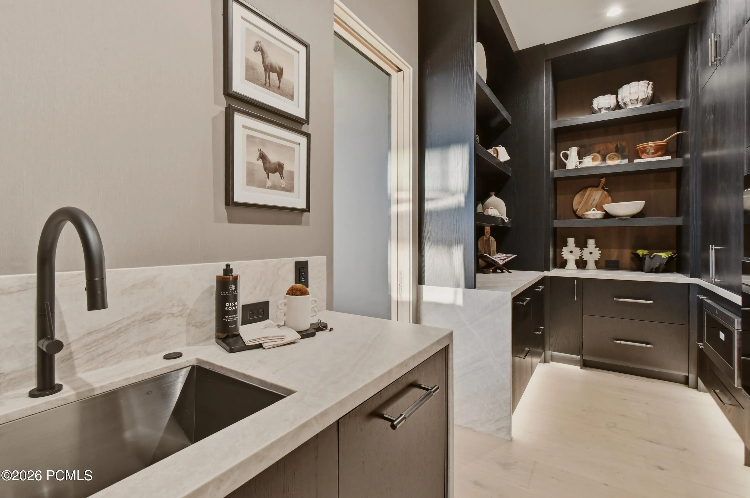 Designed for the discretion & precision of private-chef service, the butler’s pantry incorporates a dedicated prep sink & secondary dishwasher, allowing course preparation, clearing & cleanup to be managed behind the scenes while the main kitchen remains impeccably presented. Forthcoming glass pantry doors will introduce an elegant finishing detail, complementing the refinement of this dedicated service space.