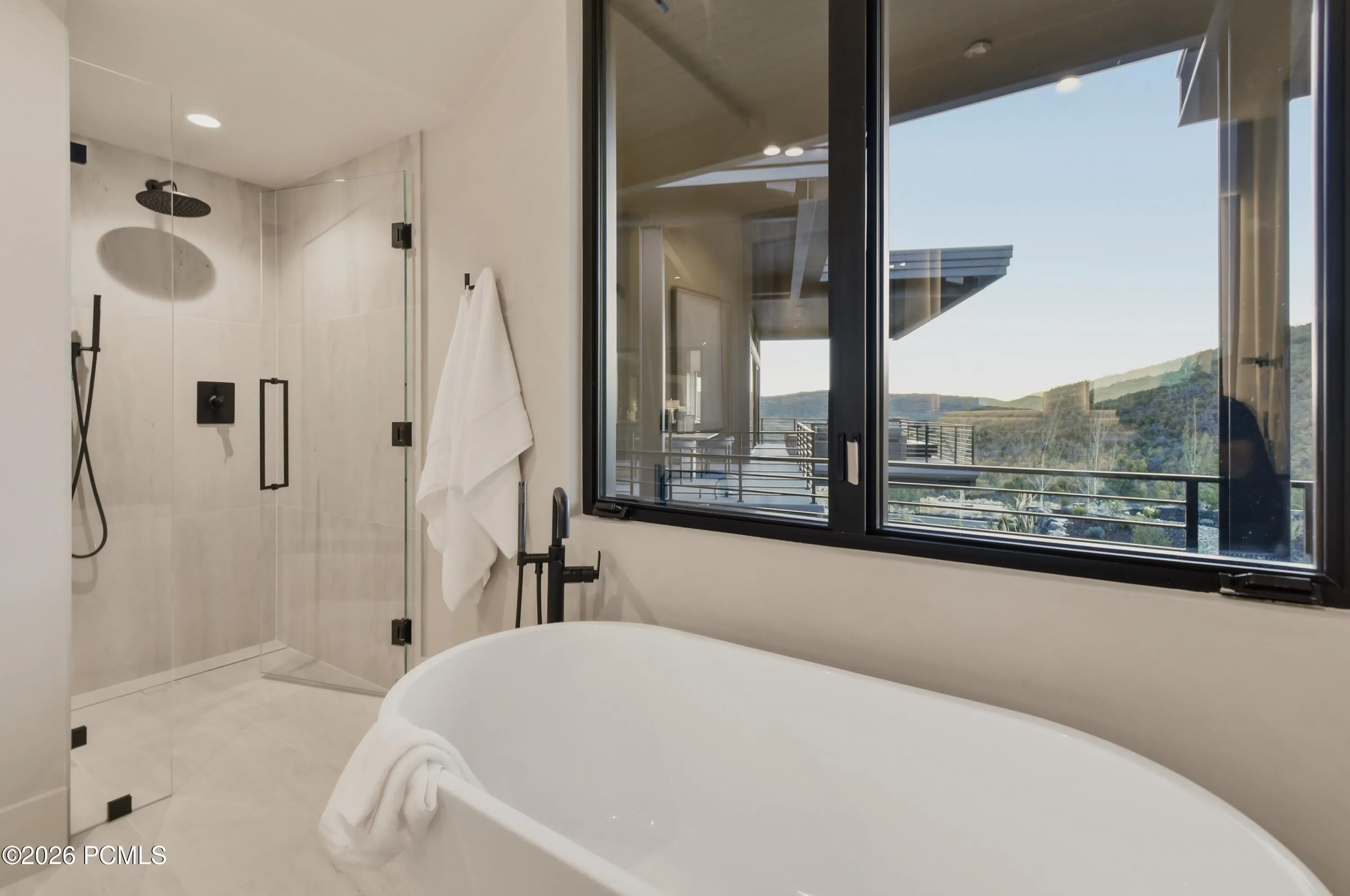 A sculptural freestanding soaking tub invites moments of serenity & an invitation to linger in complete tranquility. This elegant bathroom transforms the simple ritual of bathing into a deeply restorative experience.