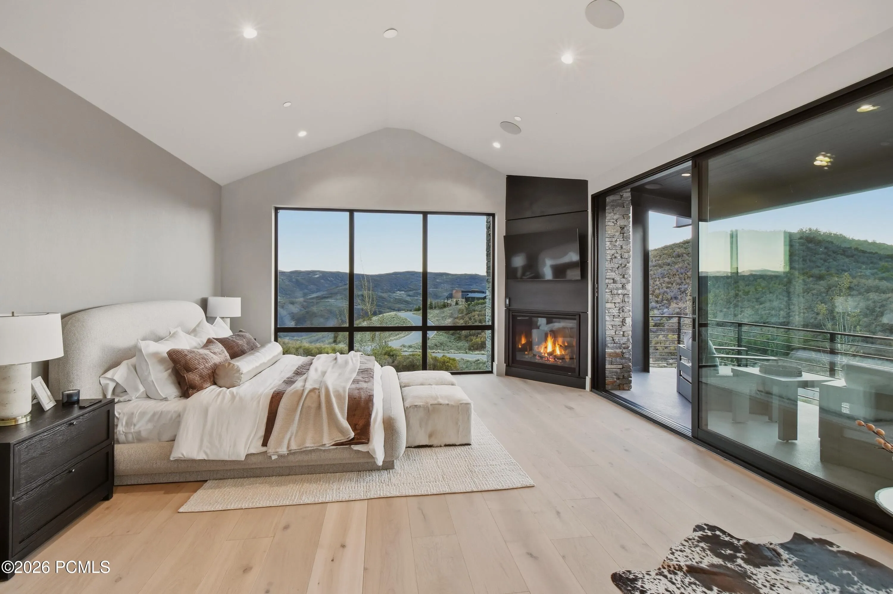 An exquisite sanctuary of refined mountain living, the primary suite is enveloped by expansive walls of glass that frame the alpine landscape as a living work of art. Dramatic vaulted ceilings introduce remarkable volume & architectural presence, while the seamless connection to the natural surroundings creates the intimate ambiance of an exclusive private retreat.