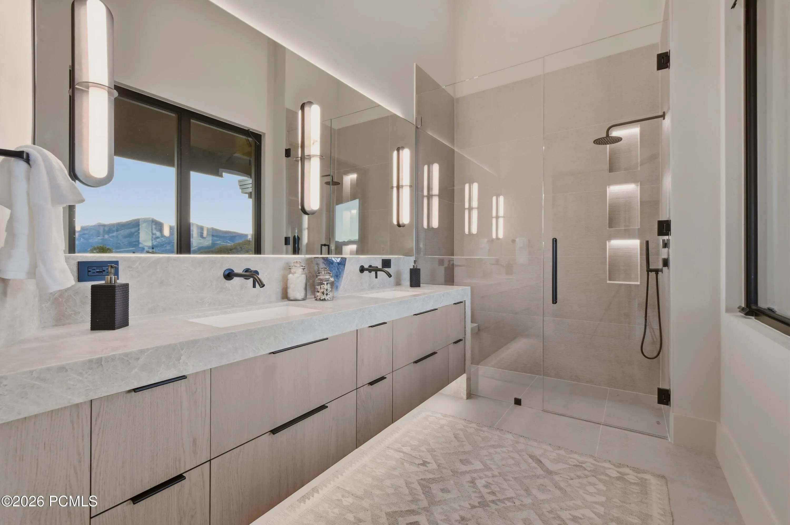 This en-suite bath rivals the indulgence of an exclusive junior suite, with elegant dual vanities, extensive storage & the comfort of radiant-heated floors. Curbless showers enclosed in pristine, frameless Starphire glass are enhanced by integrated LED illumination, while softly glowing undercabinet lighting lends a serene ambiance