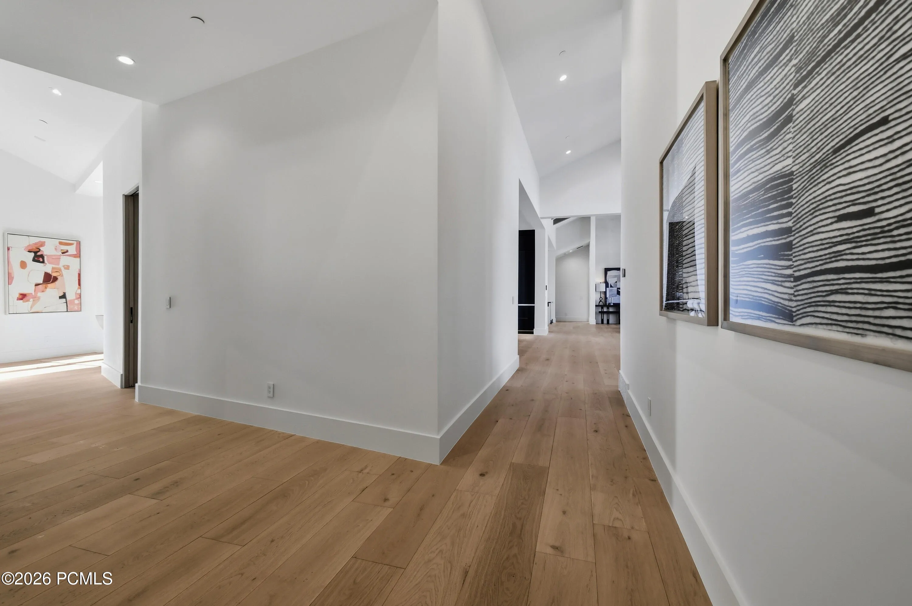 An exquisite display of architectural artistry, the hallway’s distinctive fanned configuration creates a graceful progression of widening walls, drawing the eye through an elegantly sculpted passage. This striking departure from conventional corridor design introduces remarkable depth, visual intrigue & a gallery-like presence, transforming a transitional space into an expression of exceptional craftsmanship.