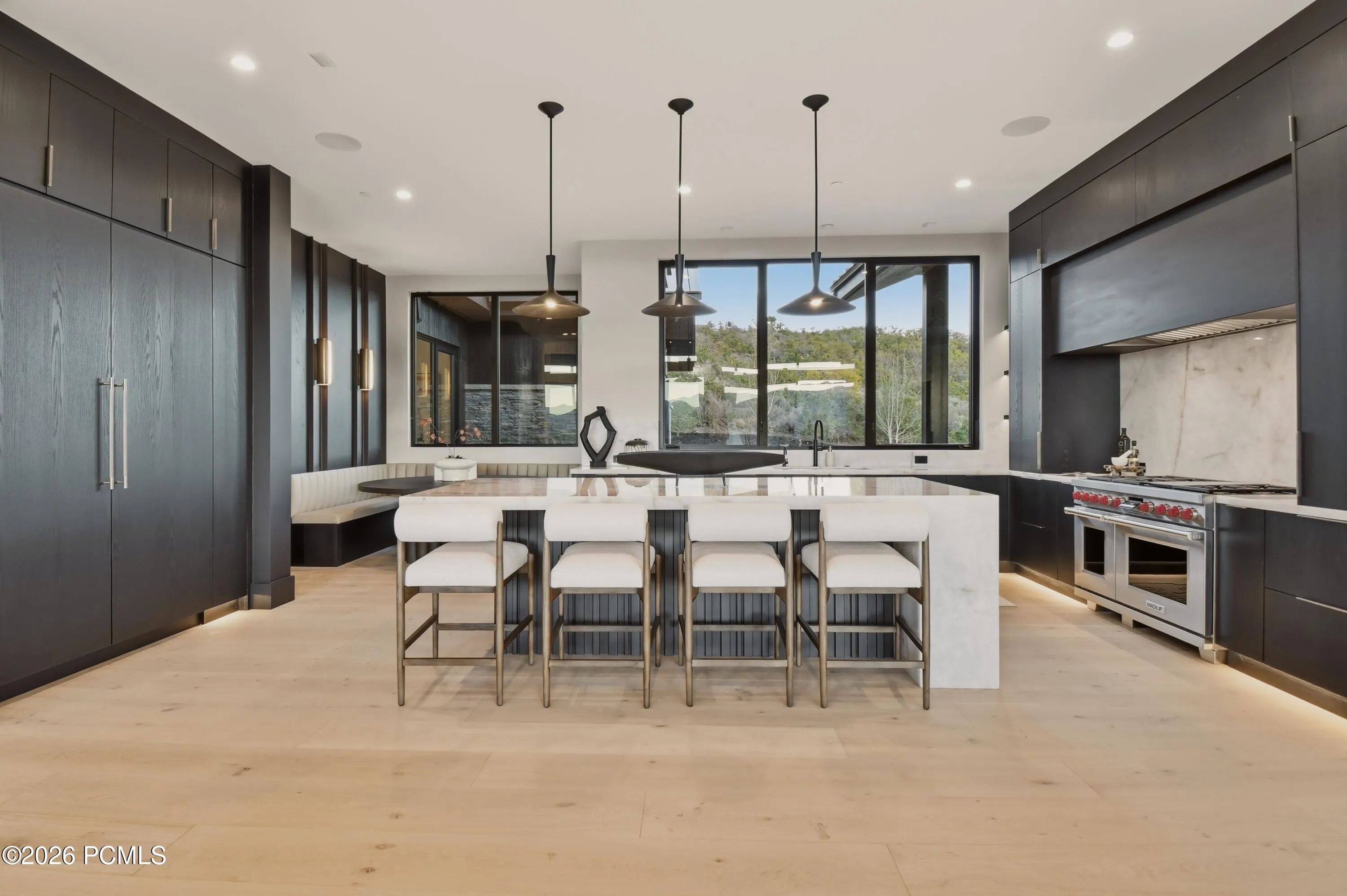 A striking quartzite waterfall island takes center stage as the kitchen’s sculptural showpiece, its dramatic stonework & refined proportions creating an expression of art. Generous seating accommodates everything from leisurely breakfasts & casual fare to an exclusive chef’s table experience, where guests enjoy a front-row seat to the art of fine cuisine.