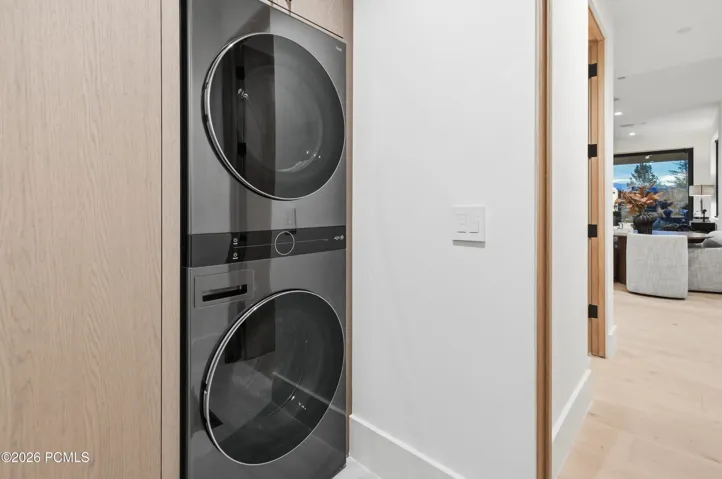 A dedicated lower level laundry suite adds a considered layer of functionality, particularly alongside the wellness wing, allowing towels, robes & post-sauna essentials to be refreshed close at hand. An intelligent amenity that complements the home’s emphasis on personal wellness & everyday ease.