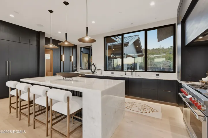 Complemented by refined cabinetry, premium Wolf & Sub-Zero appliances & meticulously curated finishes, this exceptional space balances culinary performance with understated luxury.