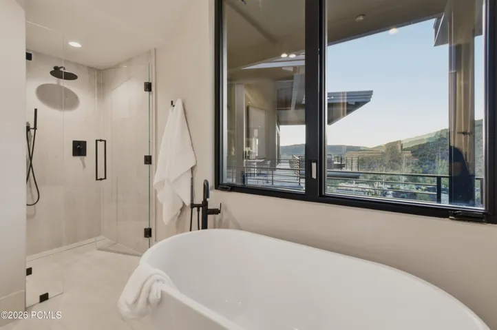 A sculptural freestanding soaking tub invites moments of serenity & an invitation to linger in complete tranquility. This elegant bathroom transforms the simple ritual of bathing into a deeply restorative experience.