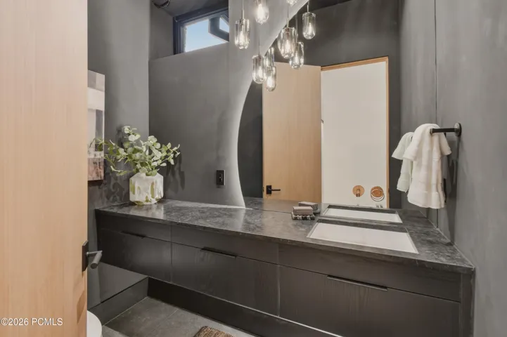 The interplay of rich surfaces, sleek cabinetry & ambient illumination creates an intimate, boutique hotel atmosphere.
