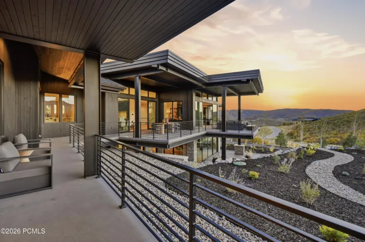 An exceptional extension of the bedroom, the continuous covered deck stretches across much of the main level, creating an elegant progression of open-air experiences against a breathtaking mountain backdrop. Begin the day with a quiet espresso just beyond your suite, then stroll along the connected deck to enjoy alfresco dining, afternoon lounging or evening cocktails beside the covered fireplace. This distinctive configuration pairs the serenity of a personal retreat with the refined pleasures of shared mountain living.