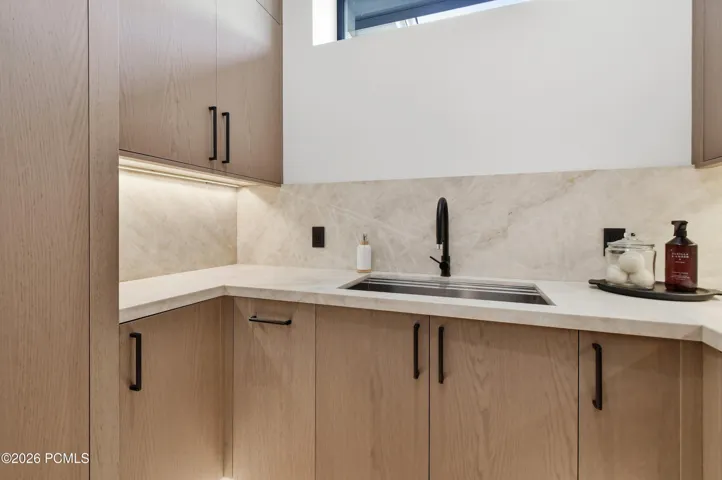 Exceptional attention to detail extends to the art of illumination, where carefully positioned LED lighting lends depth & dimension throughout the home. Even the laundry suite is distinguished by a dual layer of illumination beneath the upper & lower cabinetry, accentuating the tailored millwork, enhancing functionality & creating a warm, ambient glow.