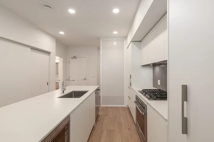 Contemporary kitchen featuring a gas range, integrated oven, and stainless steel dishwasher