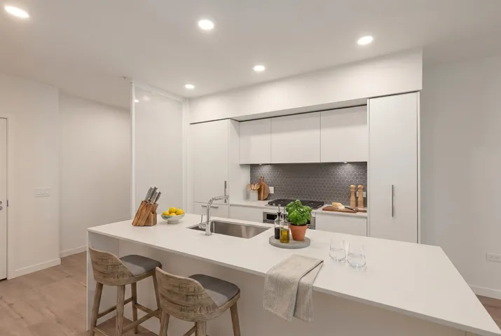 Modern kitchen featuring a large island with an undermount sink and bar seating