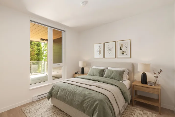Bedroom featuring light wood-finish flooring and a large window with direct balcony access