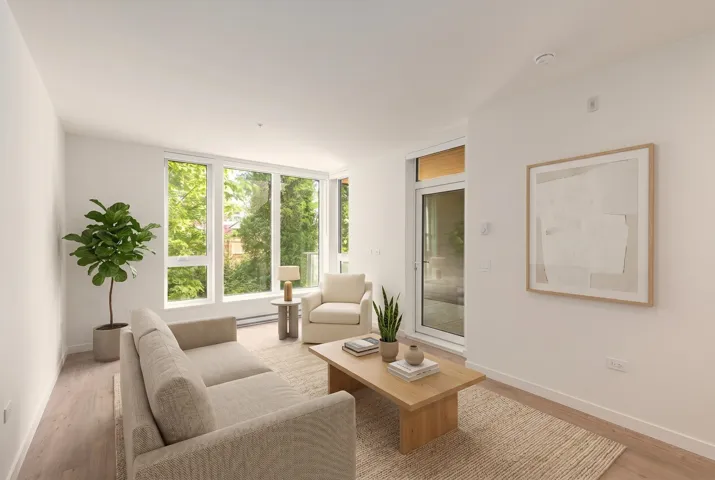 Bright living area featuring wood-finish flooring and a white color palette